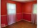 Bright bedroom featuring hardwood floors and two windows that provide natural light at 3528 Orchard Ave, Indianapolis, IN 46218