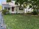 This single-story home features a cozy front porch and a spacious front yard at 3528 Orchard Ave, Indianapolis, IN 46218