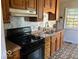 Well-lit kitchen features classic wooden cabinetry and modern appliances for efficient meal preparation at 3528 Orchard Ave, Indianapolis, IN 46218