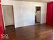 Bright living room with hardwood floors and a glimpse into the adjacent kitchen area at 3528 Orchard Ave, Indianapolis, IN 46218