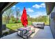 Inviting outdoor patio with seating, a picnic table, an umbrella and a lawn view at 3682 S 380 E, Anderson, IN 46017