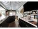 Custom bar with stainless steel counter, modern fixtures, and adjacent entertaining space, offering a unique hangout at 3682 S 380 E, Anderson, IN 46017