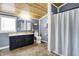 Charming bathroom with blue wainscoting, wooden ceiling, and a combination tub-shower at 3682 S 380 E, Anderson, IN 46017