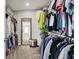 A large walk-in closet featuring organized storage and an entrance to the bathroom at 3682 S 380 E, Anderson, IN 46017