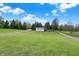 Picturesque gravel driveway winding through a lush green landscape to the home at 3682 S 380 E, Anderson, IN 46017