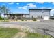 Stunning gray two-story home with a covered porch, ramp, and a gravel driveway at 3682 S 380 E, Anderson, IN 46017