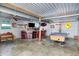 A spacious garage with a bar, seating, and a pool table, ideal for entertaining guests at 3682 S 380 E, Anderson, IN 46017