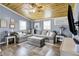 Relax in this cozy living room featuring a large sectional couch and wood plank ceiling at 3682 S 380 E, Anderson, IN 46017