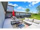 Cozy outdoor patio featuring comfortable seating, a picnic table, and a colorful rug at 3682 S 380 E, Anderson, IN 46017