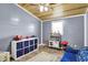 A cheerful playroom with natural light, wooden ceiling, and colorful toys at 3682 S 380 E, Anderson, IN 46017