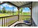 Charming porch with metal chairs overlooking a scenic driveway and lush green field at 3682 S 380 E, Anderson, IN 46017