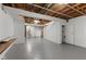 Finished basement featuring painted floors, stairs, exposed beams, and utility access at 3705 Lima Ct, Indianapolis, IN 46227
