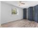 Bedroom featuring a ceiling fan, natural light, neutral paint, updated floors, and closet storage at 3705 Lima Ct, Indianapolis, IN 46227