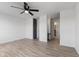 Spacious bedroom featuring a ceiling fan, neutral paint, and updated floors leading to the bathroom at 3705 Lima Ct, Indianapolis, IN 46227