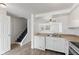 Bright kitchen featuring white cabinetry, stainless steel appliances, and a view of stairs and the living room at 3705 Lima Ct, Indianapolis, IN 46227