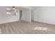 Bright living room featuring wood-look vinyl flooring, white trim, and an open layout to the kitchen at 3705 Lima Ct, Indianapolis, IN 46227