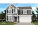 Charming two-story home with gray siding, black shutters, and a two-car garage at 379 N Post Oak Dr, Mooresville, IN 46158