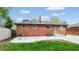 Spacious backyard featuring a patio, lush grass, and a classic brick exterior of the home at 4213 N Audubon Rd, Indianapolis, IN 46226