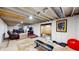 Finished basement area featuring a seating area, workout equipment, and ample open space at 4213 N Audubon Rd, Indianapolis, IN 46226