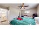 Comfortable bedroom with ceiling fan, a view to the bathroom, and ample space at 4213 N Audubon Rd, Indianapolis, IN 46226