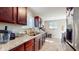 Updated kitchen featuring granite countertops, stainless steel appliances, and dark wood cabinetry at 4213 N Audubon Rd, Indianapolis, IN 46226