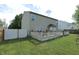 Lush backyard featuring a deck, expansive green lawn, and a white privacy fence at , Greenwood, IN 46143