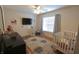 Bright bedroom featuring a ceiling fan, large window, and stylish area rug at , Greenwood, IN 46143