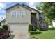 Two-story home featuring vinyl siding, brick accents, manicured landscaping, and an attached two car garage at , Greenwood, IN 46143