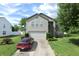 View of a two-story house with vinyl siding, brick accents, an attached garage, and a landscaped yard at , Greenwood, IN 46143