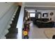 The home's foyer features carpeted stairs and entry into the living room, which features white ceramic tile at , Greenwood, IN 46143