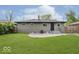 Large, level, green backyard with patio and a freshly painted home at 4337 N Audubon Rd, Indianapolis, IN 46226