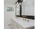 Elegant bathroom with double sinks, a modern mirror, and stylish gold fixtures at 4337 N Audubon Rd, Indianapolis, IN 46226