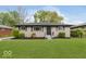 Exterior shot of renovated house including new landscaping and expansive front lawn at 4337 N Audubon Rd, Indianapolis, IN 46226