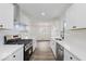 Modern kitchen with white cabinets, stainless steel appliances, and an open concept design at 4337 N Audubon Rd, Indianapolis, IN 46226