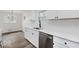 New kitchen features stainless steel dishwasher, granite counters, and modern faucet fixtures at 4337 N Audubon Rd, Indianapolis, IN 46226