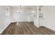 Sun-filled living room showcasing open floor plan, contemporary chandelier, and breakfast bar at 4337 N Audubon Rd, Indianapolis, IN 46226