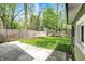 Lush backyard featuring patio, grass lawn, garden boxes and a wooden fence at 4447 N College Ave, Indianapolis, IN 46205