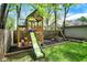 Playground in backyard on mulch with slide, climbing wall, and swing at 4447 N College Ave, Indianapolis, IN 46205