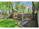 The backyard includes a playground, wooden fence, and mulched area at 4447 N College Ave, Indianapolis, IN 46205