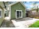 The backyard features a light green house with a concrete patio and sliding door to the backyard at 4447 N College Ave, Indianapolis, IN 46205