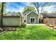 A spacious green backyard with a light green house, garage and lawn at 4447 N College Ave, Indianapolis, IN 46205