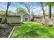 Spacious backyard with a light green house, garage, and a playground at 4447 N College Ave, Indianapolis, IN 46205