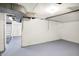 Unfinished basement space with painted walls, ladder, and drop ceiling lights at 4447 N College Ave, Indianapolis, IN 46205