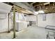 Bright basement featuring laundry area with washer, dryer, utility sink, and ample space for storage or renovation at 4447 N College Ave, Indianapolis, IN 46205