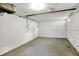Clean basement with painted block walls, concrete floor, and visible pipes ready for renovation and storage at 4447 N College Ave, Indianapolis, IN 46205