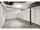 Unfinished basement featuring white walls, concrete floor, and exposed beams offering ample storage or living space at 4447 N College Ave, Indianapolis, IN 46205