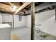 Spacious unfinished basement with exposed ceiling, concrete floor, and white painted walls ready for customization at 4447 N College Ave, Indianapolis, IN 46205