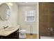 A functional bathroom with tiled shower, modern fixtures, and a granite countertop vanity at 4447 N College Ave, Indianapolis, IN 46205