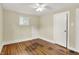 A charming bedroom with hardwood floors, a ceiling fan, and a bright window at 4447 N College Ave, Indianapolis, IN 46205