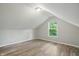 Cozy bedroom with light gray walls and beautiful hardwood floors, offering a serene and inviting space at 4447 N College Ave, Indianapolis, IN 46205